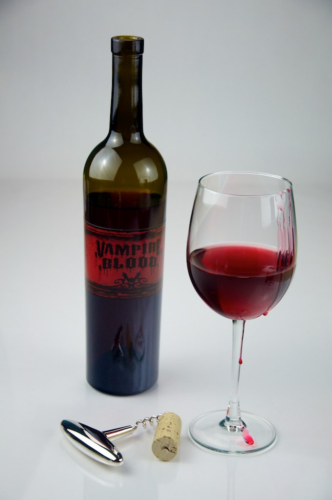A bottle of vampire blood... err, wine. With a cork, and glass full of red. Wine, that is!