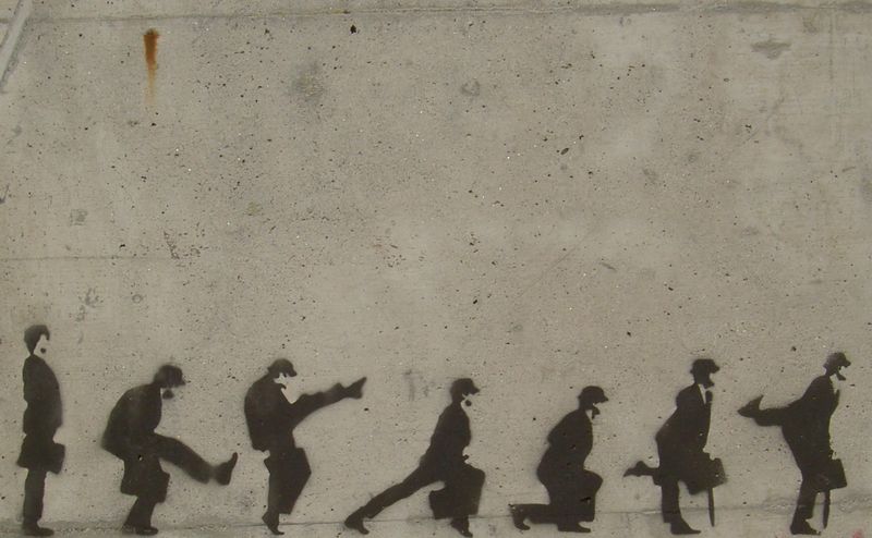 Grafitti art showing a procession of silly walks (ala John Cleese in Monty Python)