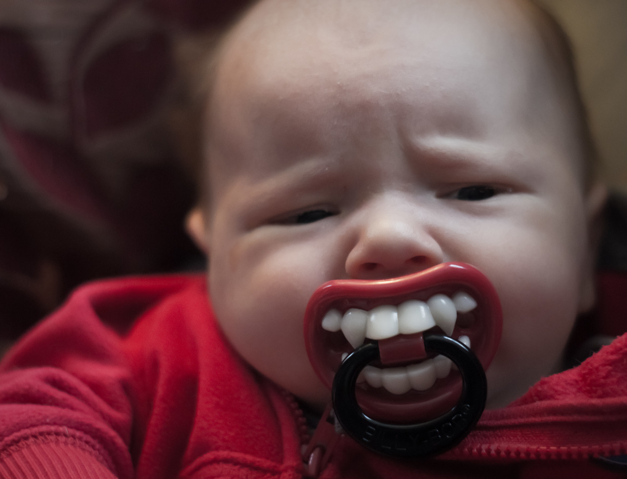 This baby has a fang shaped pacifier - or does he?